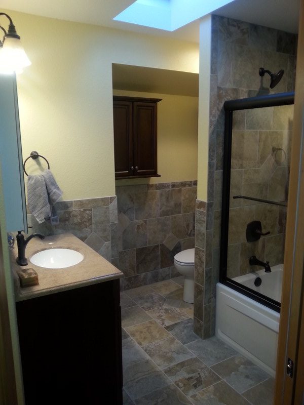A Colorado Springs bathroom remodel with new cabinetry, shower door, fixtures, and tiles