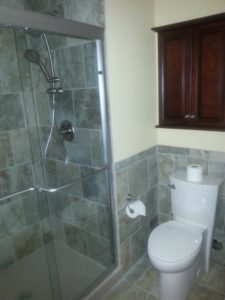 A Colorado Springs bathroom remodel with new fixtures, shower door, and tiles